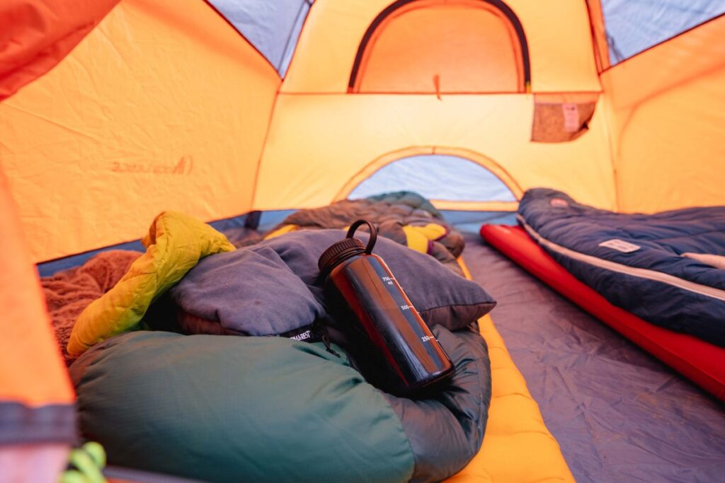 Nalgene water bottle filled with hot water inside a tent